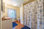 Primary suite en suite tub-shower bathroom and laundry